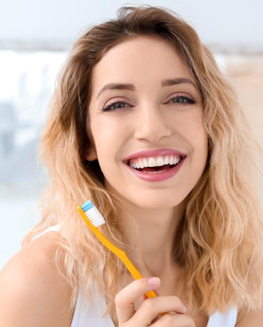 woman smiling with tooth brush 1
